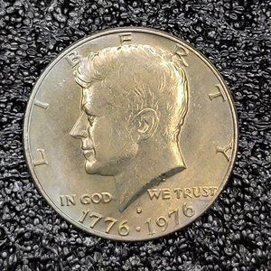 1776-1976 bicentennial Kennedy half dollar D Mint Mark. Light Rainbow toning.